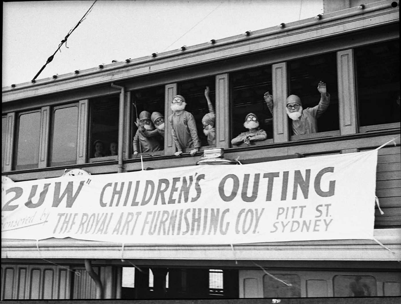 Gnomes looking out window of Kuttabul Ferry, during 2UW Harbour Cruise, 1937