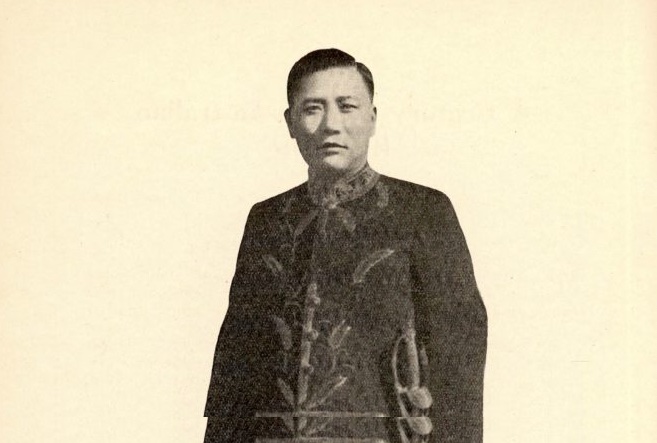 A black and white photo on a cream background of a man in traditional Chinese jacket, who is Pao, Chun-Jien, portrait from his pamphlet (1938). A Century of Sino-Australian Relations. Sydney: John Sands.